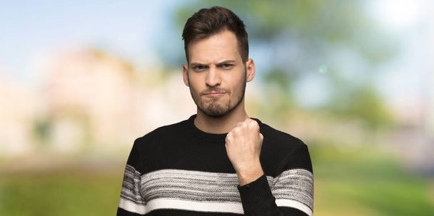 Handsome man with angry gesture at outdoors - Foto, Bild