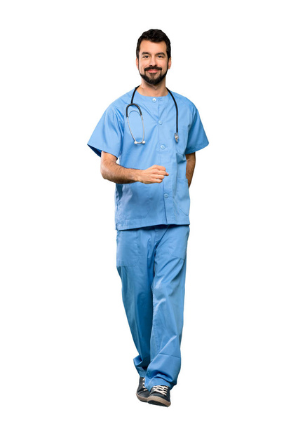 Full-length shot of Surgeon doctor man walking over isolated white background - Foto, Imagem