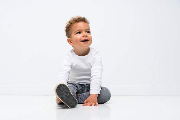 Happy kid over isolated white background - Photo, Image