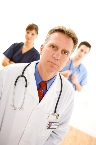 Doctors: Serious Male Doctor and Nurses - Φωτογραφία, εικόνα