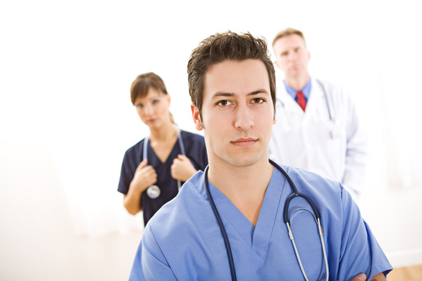 Doctors: Concerned Medical Intern with Others - Foto, Imagen