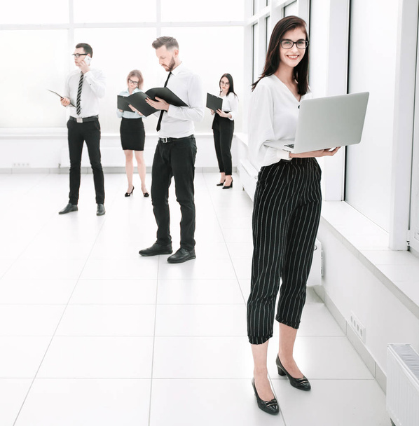 employees of the company standing in a spacious office lobby. - Foto, immagini