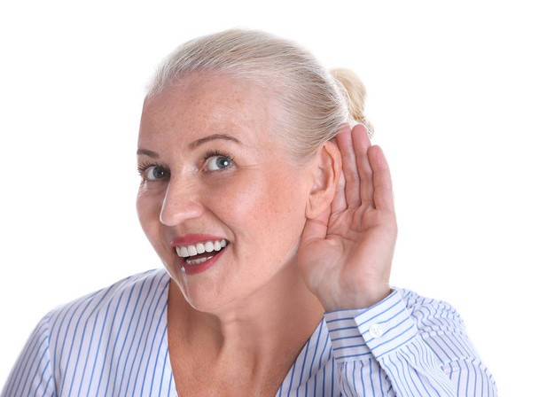 Mature woman with hearing problem on white background - Foto, imagen