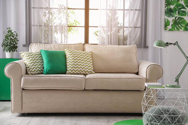 Comfortable couch near window in modern living room interior - Φωτογραφία, εικόνα