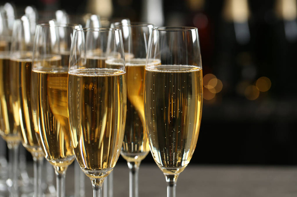 Many glasses of champagne on blurred background, closeup - 写真・画像