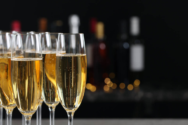 Many glasses of champagne on blurred background, closeup - Photo, Image