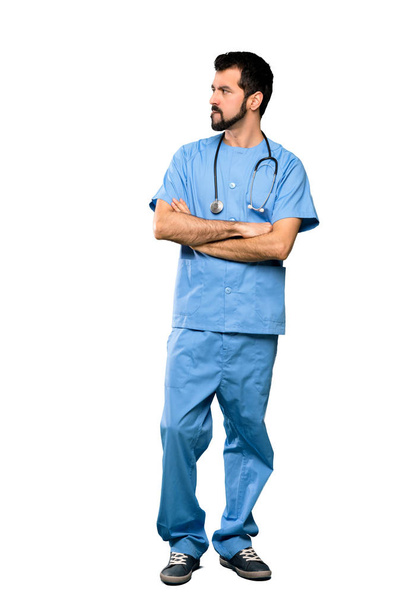 Full-length shot of Surgeon doctor man with confuse face expression over isolated white background - Foto, Bild