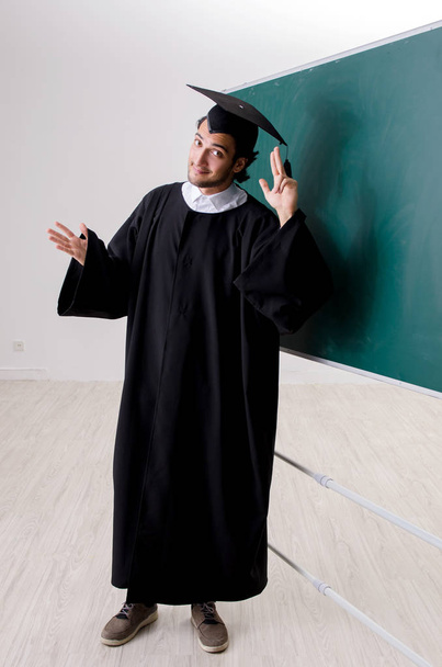 Graduate student in front of green board  - Fotoğraf, Görsel