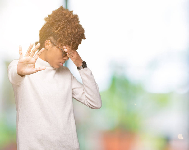 Beautiful young african american woman wearing glasses over isolated background covering eyes with hands and doing stop gesture with sad and fear expression. Embarrassed and negative concept. - Photo, Image