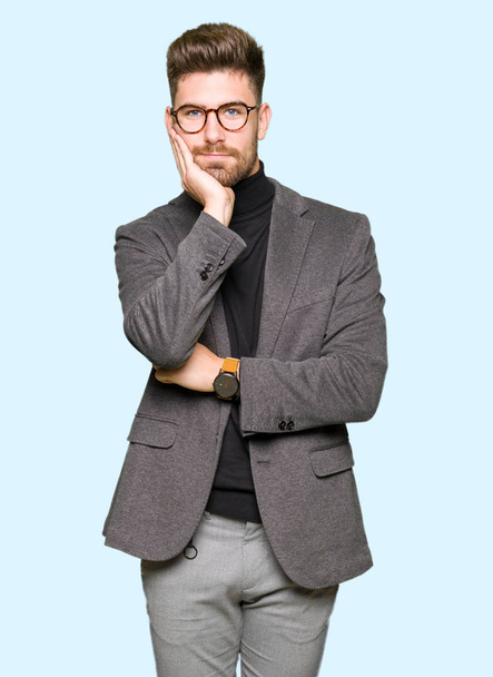 Young handsome business man wearing glasses thinking looking tired and bored with depression problems with crossed arms. - Photo, Image