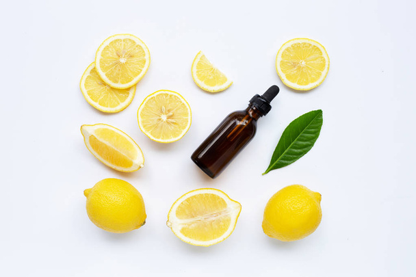 Fresh lemon with lemon essential oil on white background. - Photo, Image