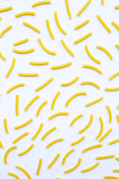 Uncooked macaroni on a white background. - Φωτογραφία, εικόνα
