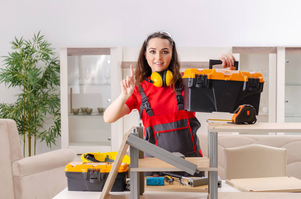 Female contractor repairing furniture at home  - Photo, Image