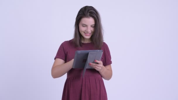 Happy young beautiful pregnant woman thinking while using digital tablet - Video, Çekim