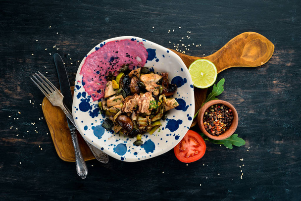 Unagi Salad with chicken, mushrooms, vegetables and pumpkin seeds. On a wooden background. Top view. Free space for your text. - Fotografie, Obrázek