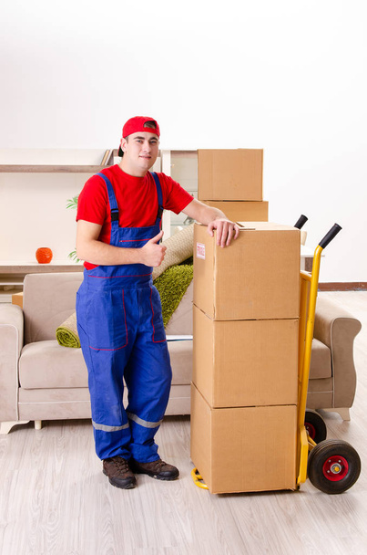 Young contractor with boxes working indoors  - Photo, Image