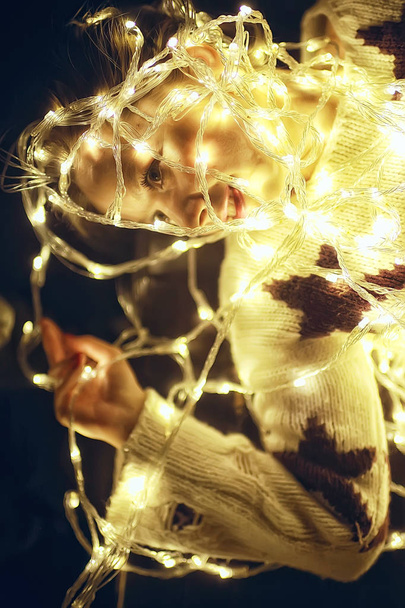 girl with Christmas garland / new year evening, funny illumination, portrait of a dream model - Foto, Imagen