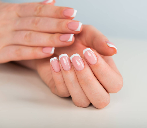 Beautiful woman's hands with beautiful nails after manicure salon with french manicure - Fotografie, Obrázek