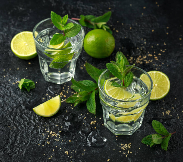 Mojito cocktail with Rum, lime and mint in glass. Summer cold drink with ice - Photo, Image