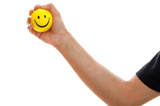 Man holding a yellow smiley emoticon - Valokuva, kuva