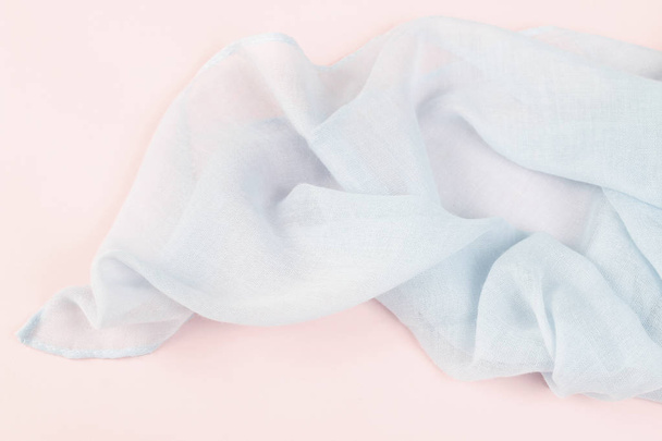 Blue scarf on pink background.  - Foto, afbeelding