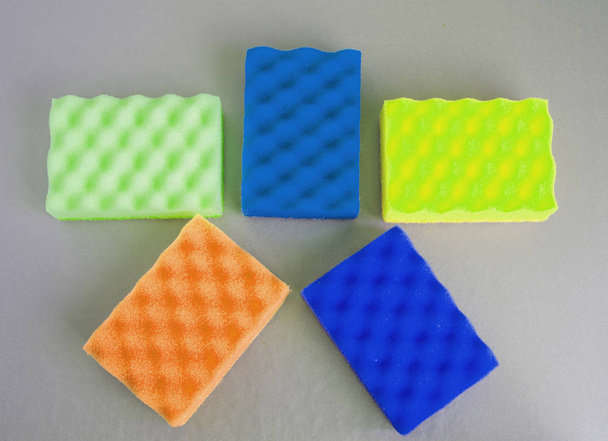 Set of five sponges for cleaning and cleanliness, laid out in the shape of a star on a gray background, cleaning concept, top view, FLAT LAY - Φωτογραφία, εικόνα