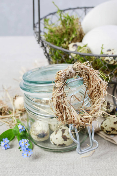 Tiny hay wreath on glass jar with quail eggs - Foto, Imagem