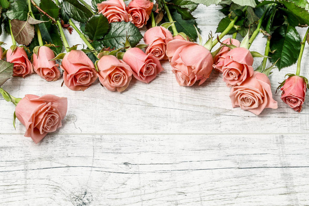 Beautiful roses on wooden background - Fotó, kép