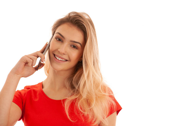 Beautiful young woman in red t shirt speak on a smart phone isol - Foto, Imagem