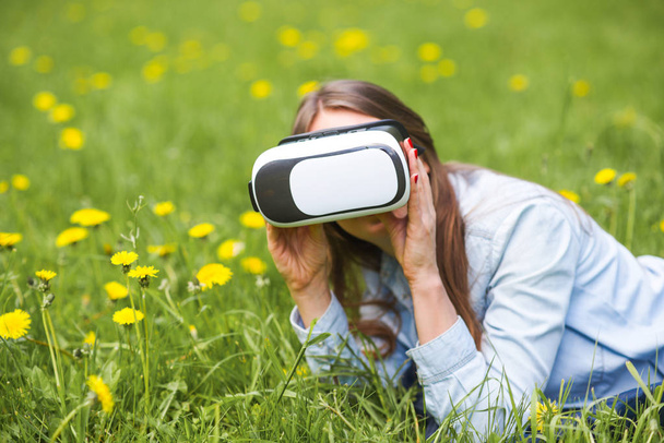 Woman in virtual reality headset outdoors - Фото, зображення