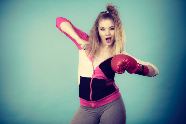 Funny girl in red gloves playing sports boxing - Fotoğraf, Görsel