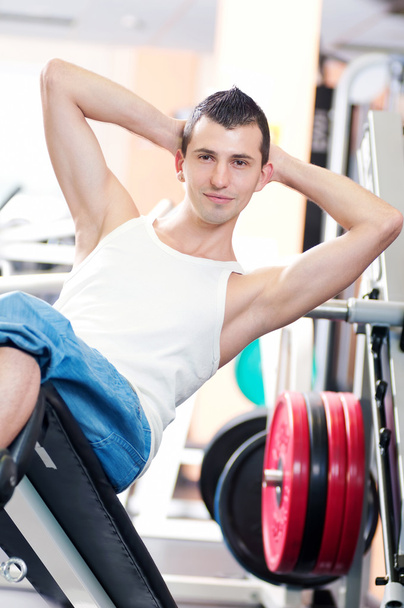 Young man doing exercises at gym - Fotoğraf, Görsel