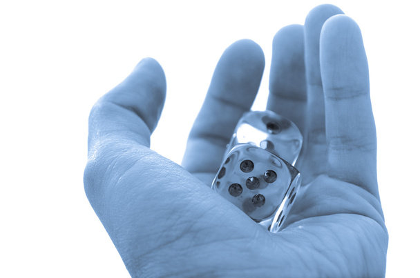 Male hand holding a pair of dice - Foto, afbeelding