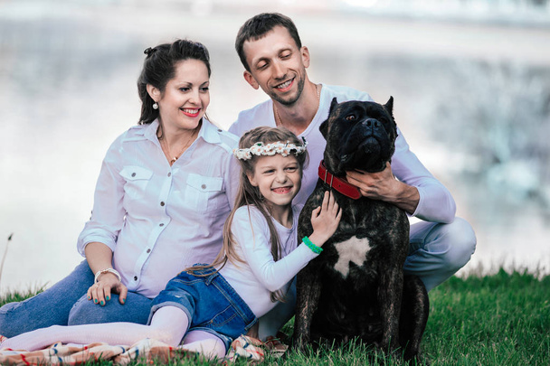 portrait of happy family with their pet outdoors - Fotografie, Obrázek