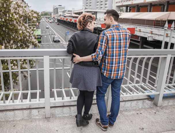 portrait of loving couple standing on bridge in big city - Foto, immagini