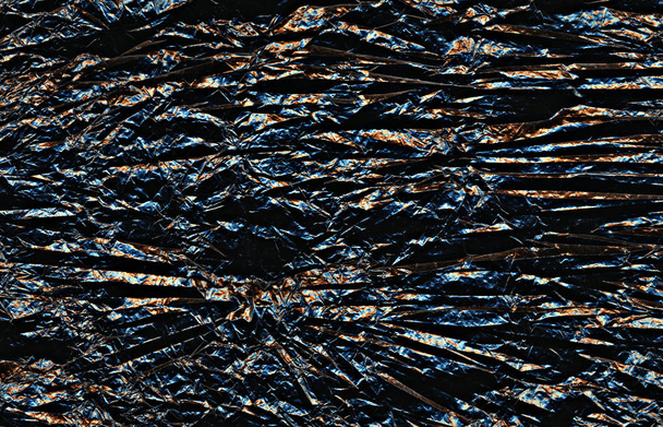 Dark multicolored crumpled broken rough wrinkled crease texture. Dark background - Фото, зображення