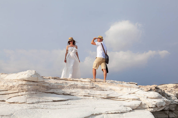 Happy young couple posing on white cliff near sea, Cyprus. - Фото, изображение