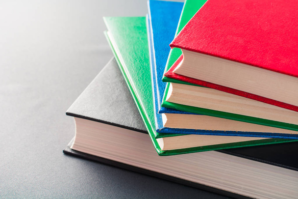 Beautiful colorful books lie on a gray background - Photo, Image