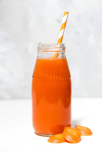 fresh carrot juice in a bottle, closeup - Фото, изображение