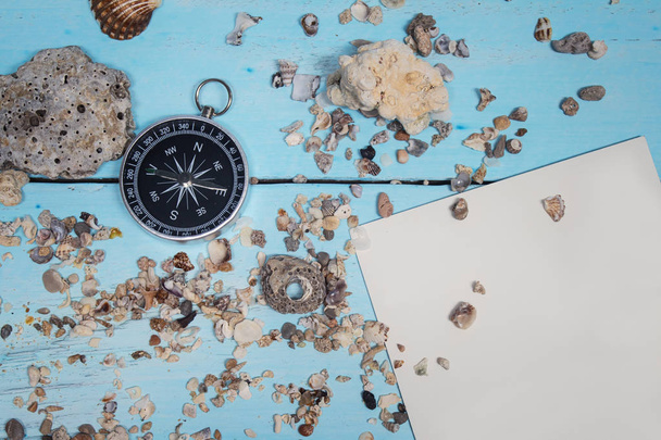 Time to Travel. Idea for tourism with compass on the sand with corals on the wooden background. - Φωτογραφία, εικόνα