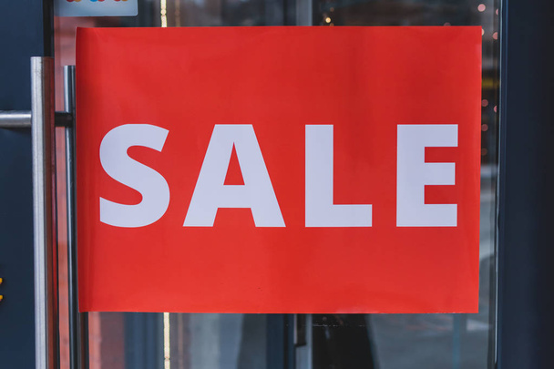 Sale sign on the door of fashion store. Discount, retail sign. Shopping mall. - Photo, Image