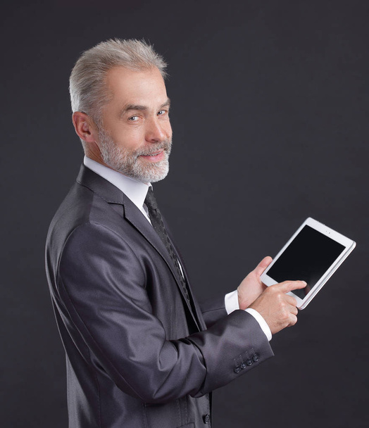 modern businessman using digital tablet.isolated on black background - 写真・画像