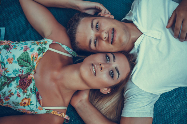 Top view of young couple at picnic lying down on blanket - Fotoğraf, Görsel