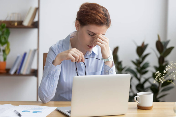 Overworked stressed business woman holding glasses feel eye strain - Φωτογραφία, εικόνα