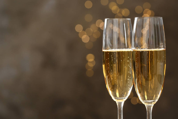Glasses of champagne on blurred background, closeup. Space for text - Valokuva, kuva