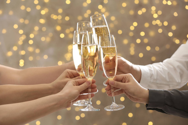 People clinking glasses of champagne on blurred background, closeup - Photo, Image
