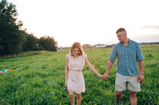 Young attractive couple in love in summer day in field - Foto, immagini