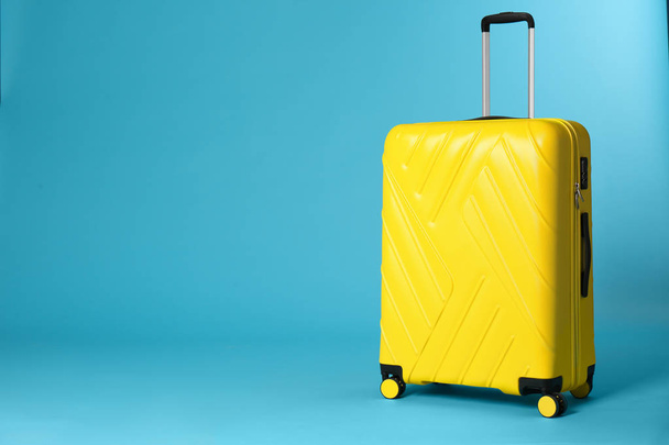 Stylish suitcase on color background. Space for text - Fotó, kép