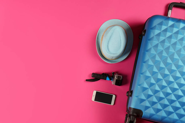 Flat lay composition with suitcase and traveler's accessories on color background. Space for text - Foto, Imagem