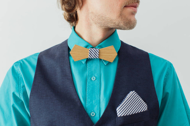 Man in a green shirt with beard in a wooden bow tie - Photo, Image